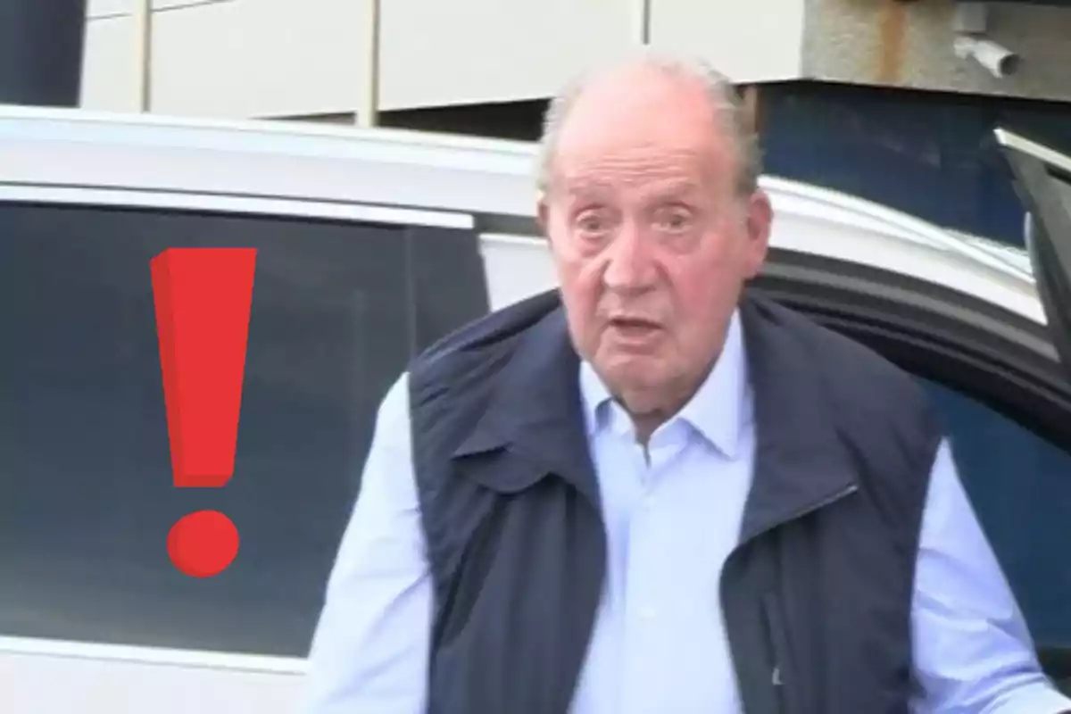 Older man with a surprised expression next to a large red exclamation mark in front of a white car Older man with a surprised expression next to a large red exclamation mark in front of a white car